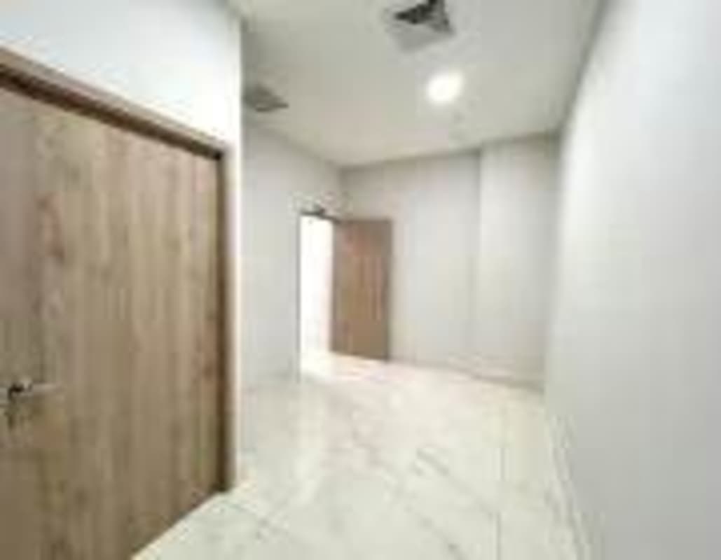 Empty modern room with marble floors and accent wall at Costa del Este PH Town Center