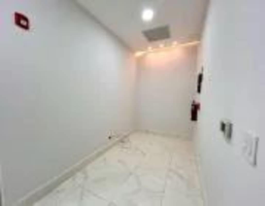Empty white painted room with marble floor inside medical office Costa del Este