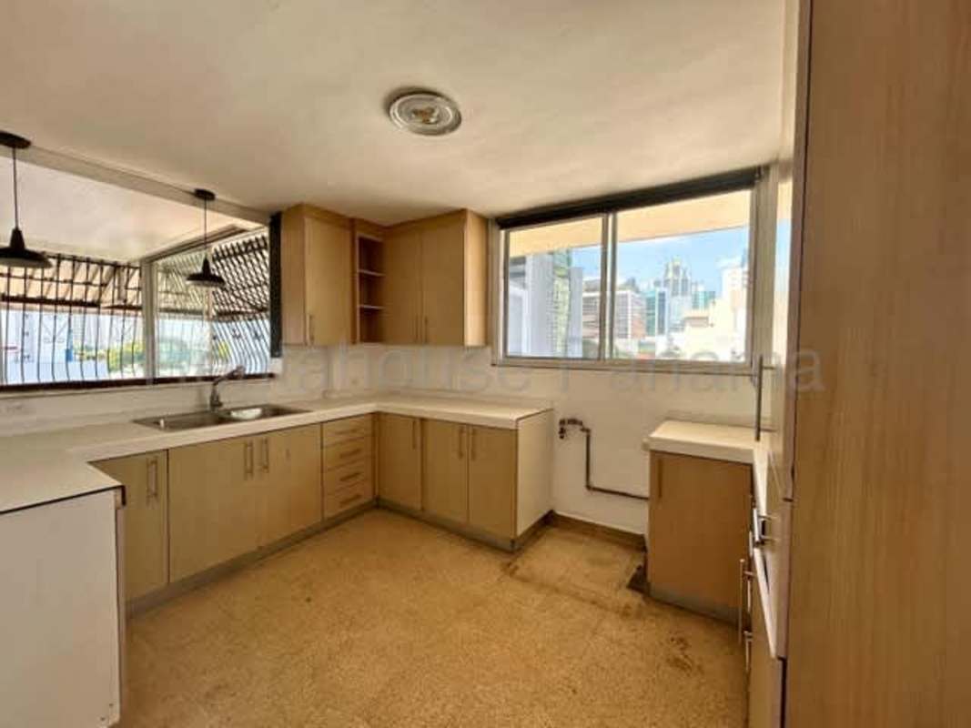 Kitchen with city view window, wood cabinetry, double sink Panama