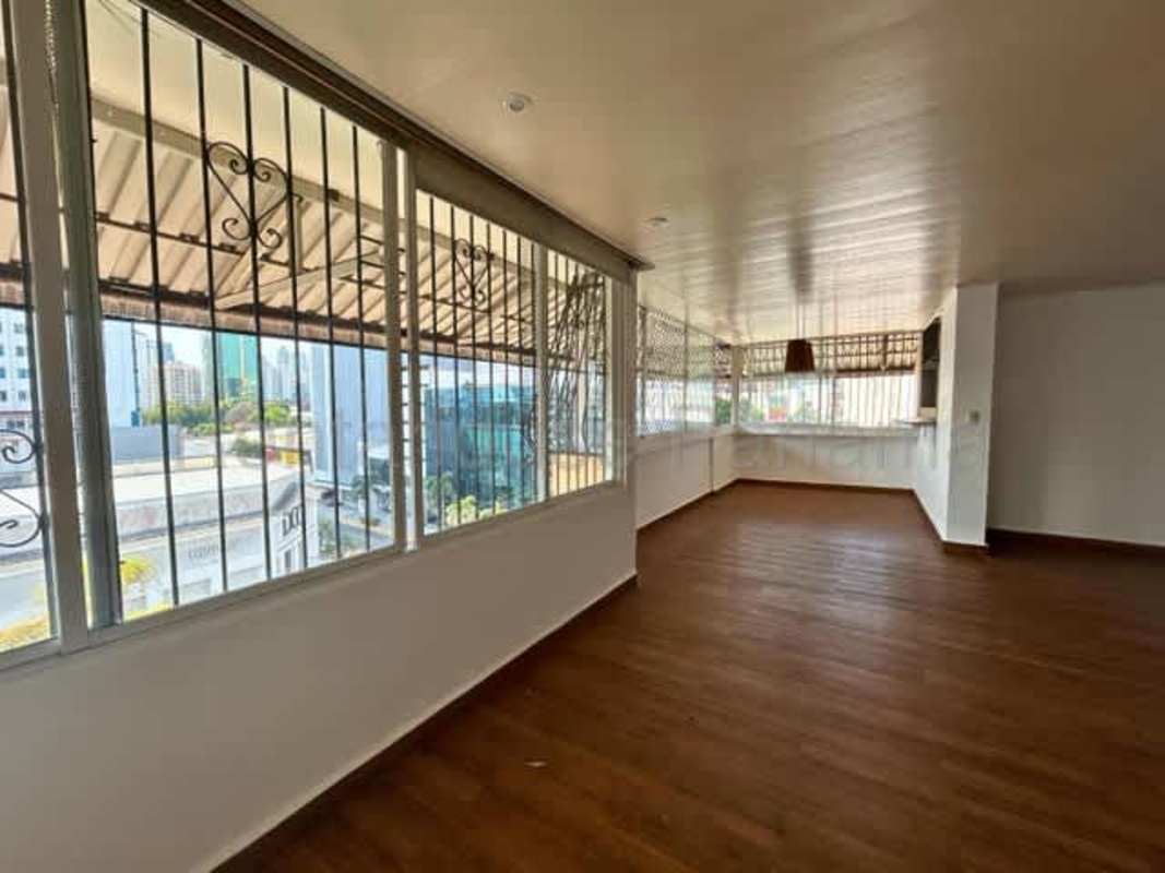 Bright enclosed balcony space with large windows and wood flooring Panama