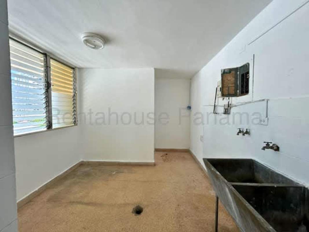 Laundry room with concrete sink and ventilation windows Panama apartment