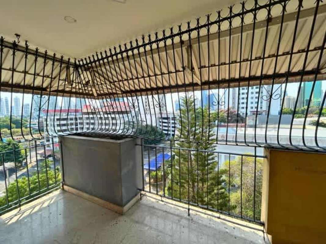 Bedroom with wood floor, built-in wardrobes, ceiling fan in Panama City condo