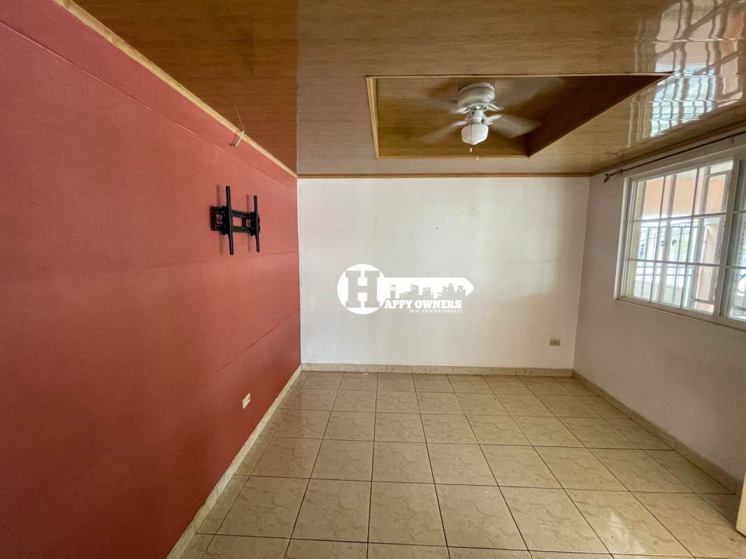 Bedroom with security window and ceramic tile floor in Tocumen Panama house