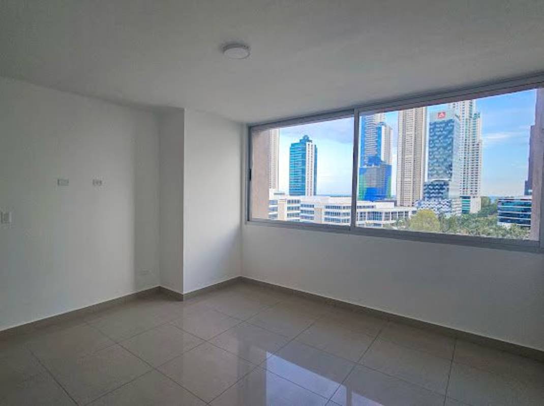 Master bedroom with large window and city skyline view Costa del Este Tower