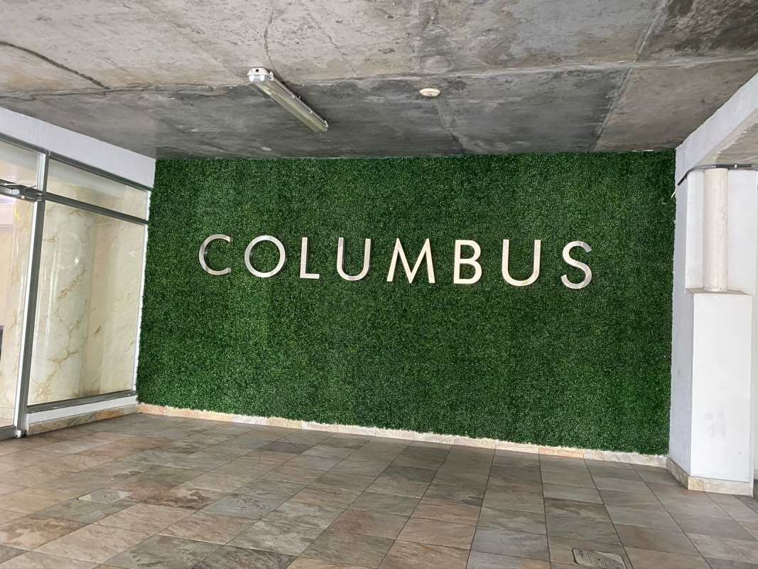 Entrance lobby with green wall and PH signage at PH Central Park, 12 Octubre Panama