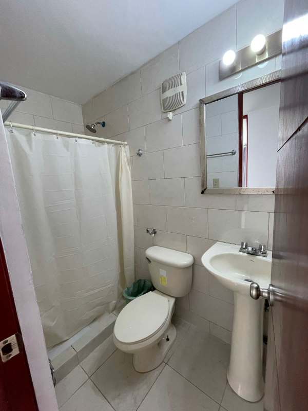 Building lobby with sofa, accent lighting, textured wall PH Central Park Panama City