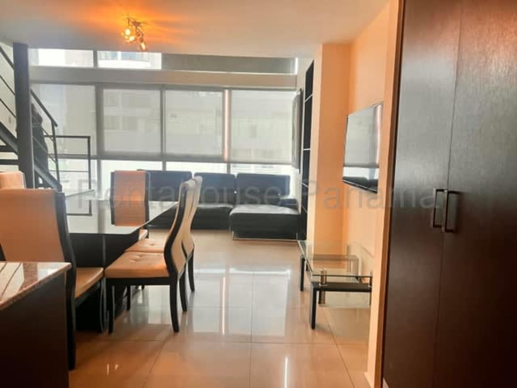 Metal staircase leading up to lofted bedroom area in modern apartment PH Park Loft El Cangrejo