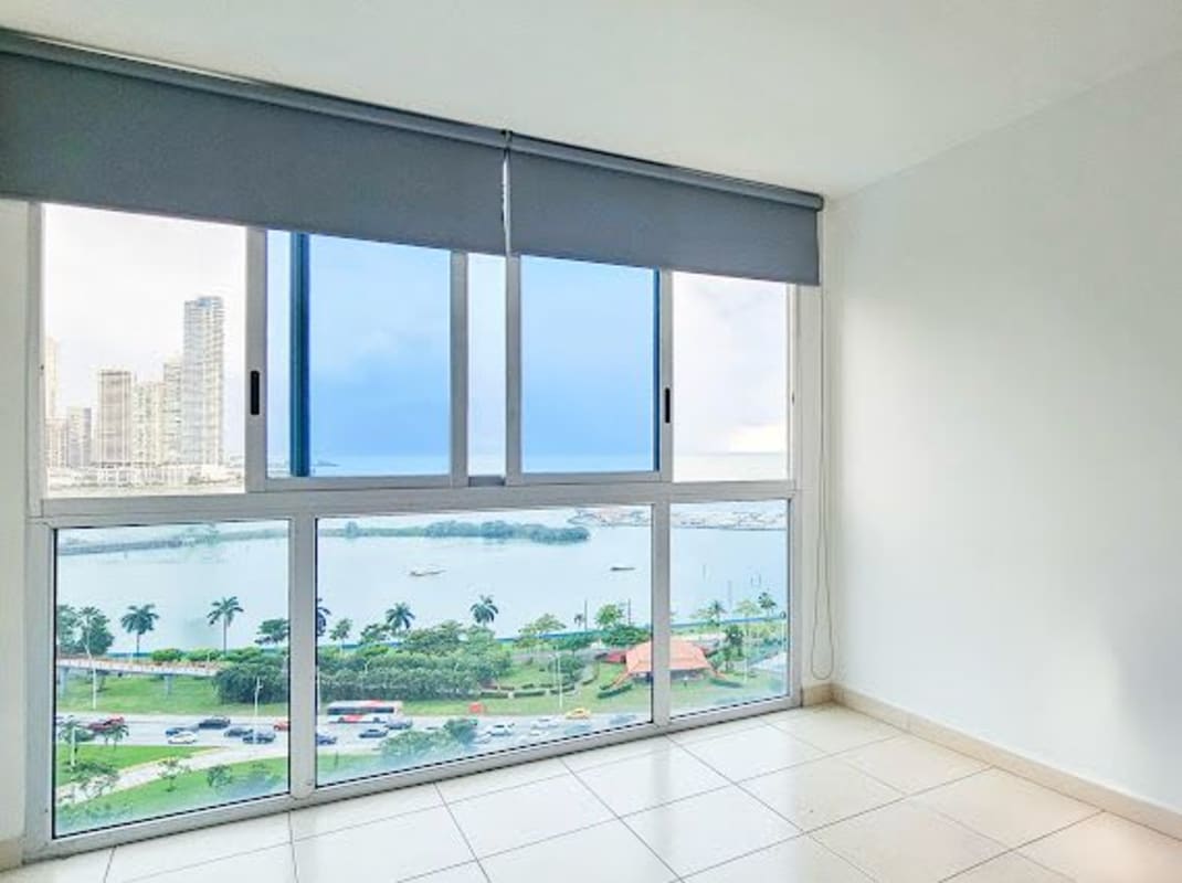 Bathroom with marble tile, glass shower and modern vanity at PH BICSA Tower Panama