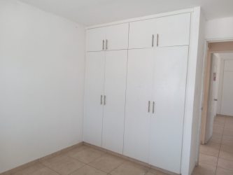 Bedroom with built-in closet and tiled floor in house for sale Brisas del Golf Arraiján Panama