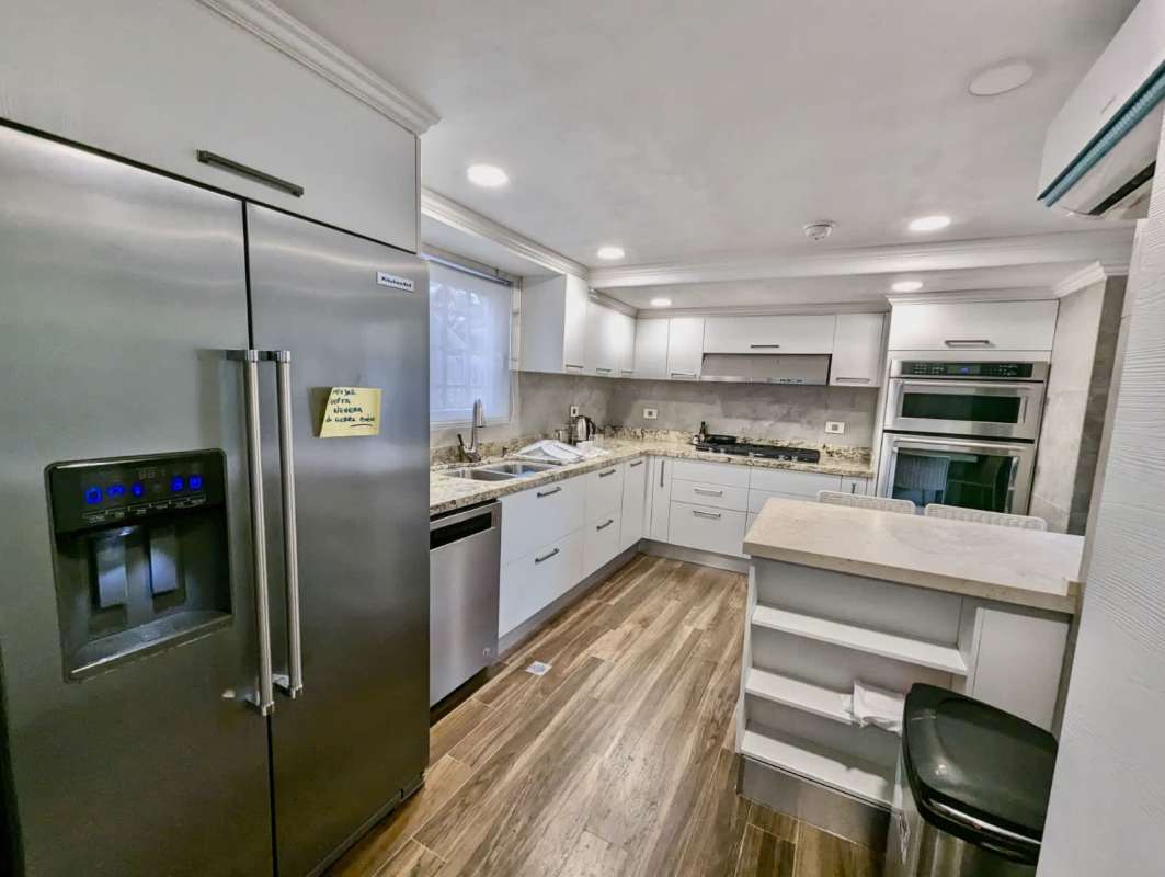 Kitchen with modern cabinetry and laundry connection area in apartment Albrook Residences Panama City