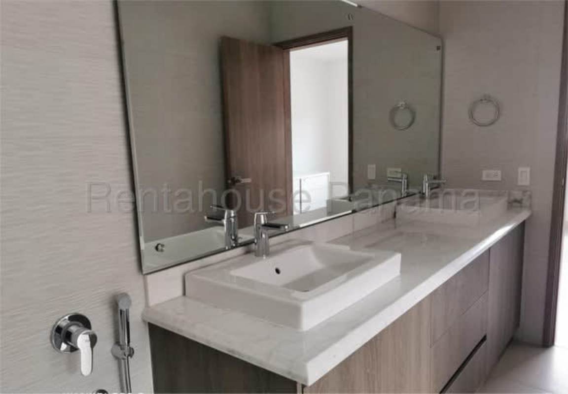 Community swimming pool with landscaped gardens in Altos del Parque Condado del Rey Panama