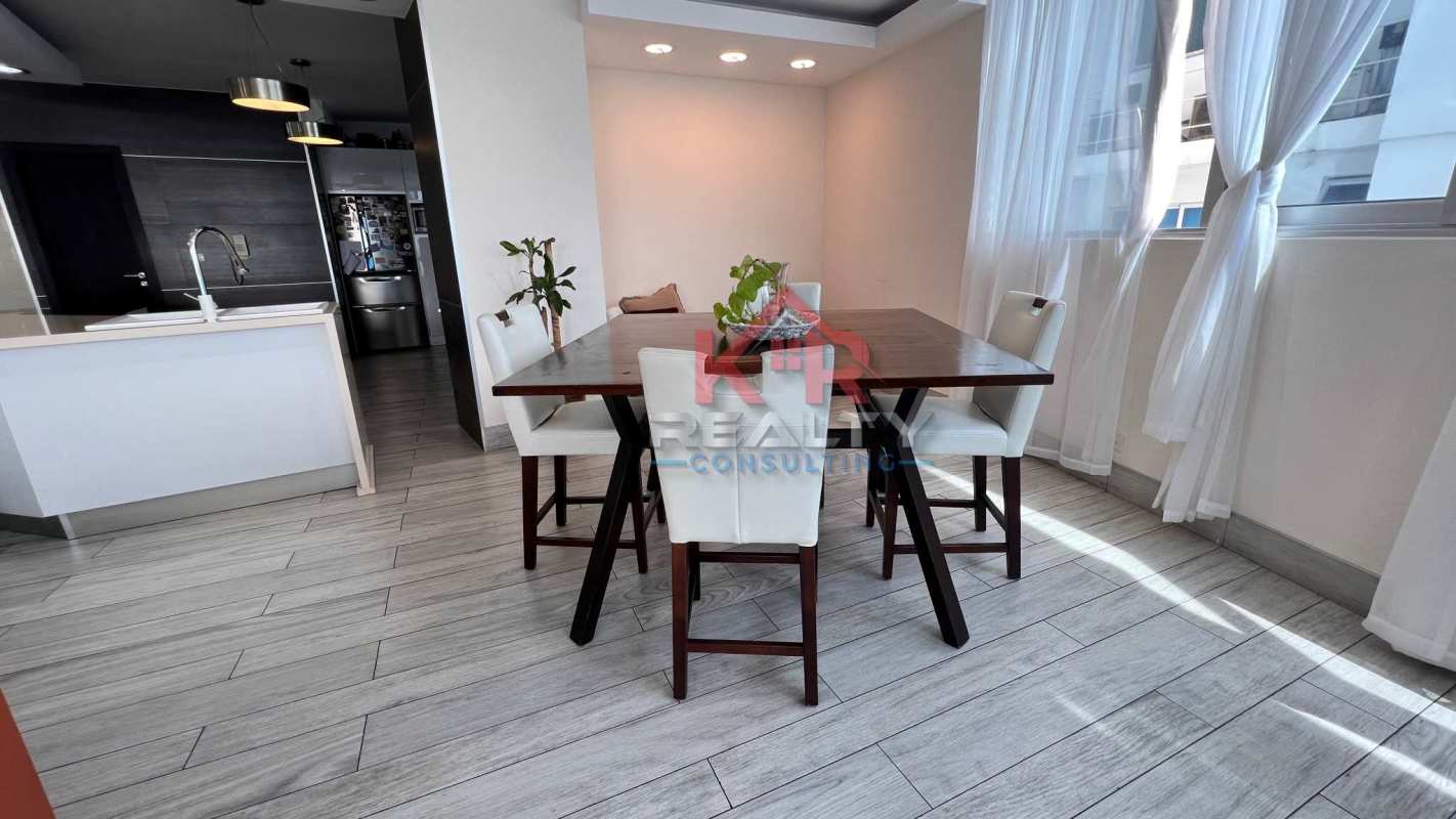 Dining area with floor-to-ceiling windows and modern lighting at PH Joy San Francisco Panama City