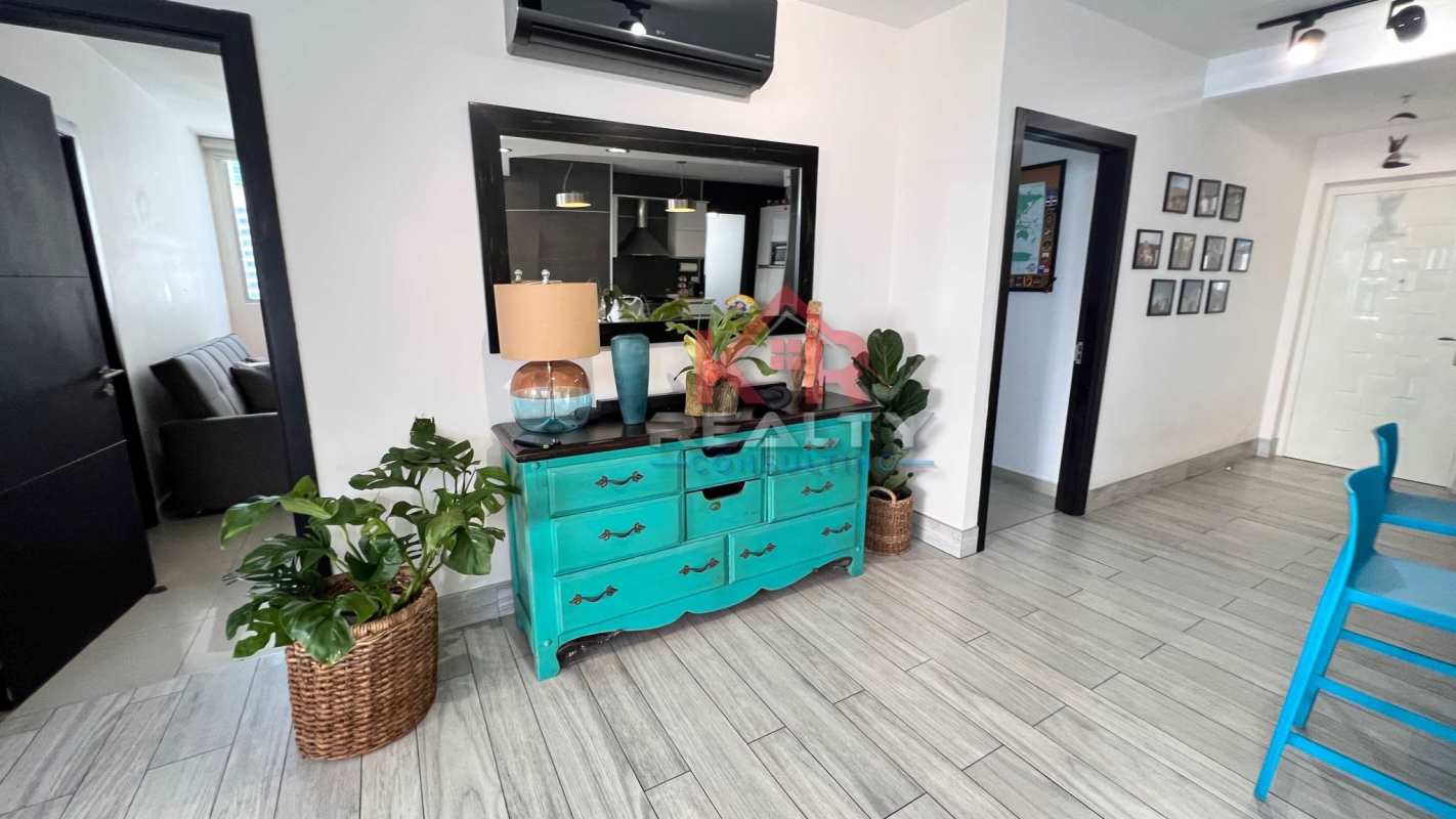Open kitchen with island, blue bar stools and track lighting PH Joy San Francisco Panama
