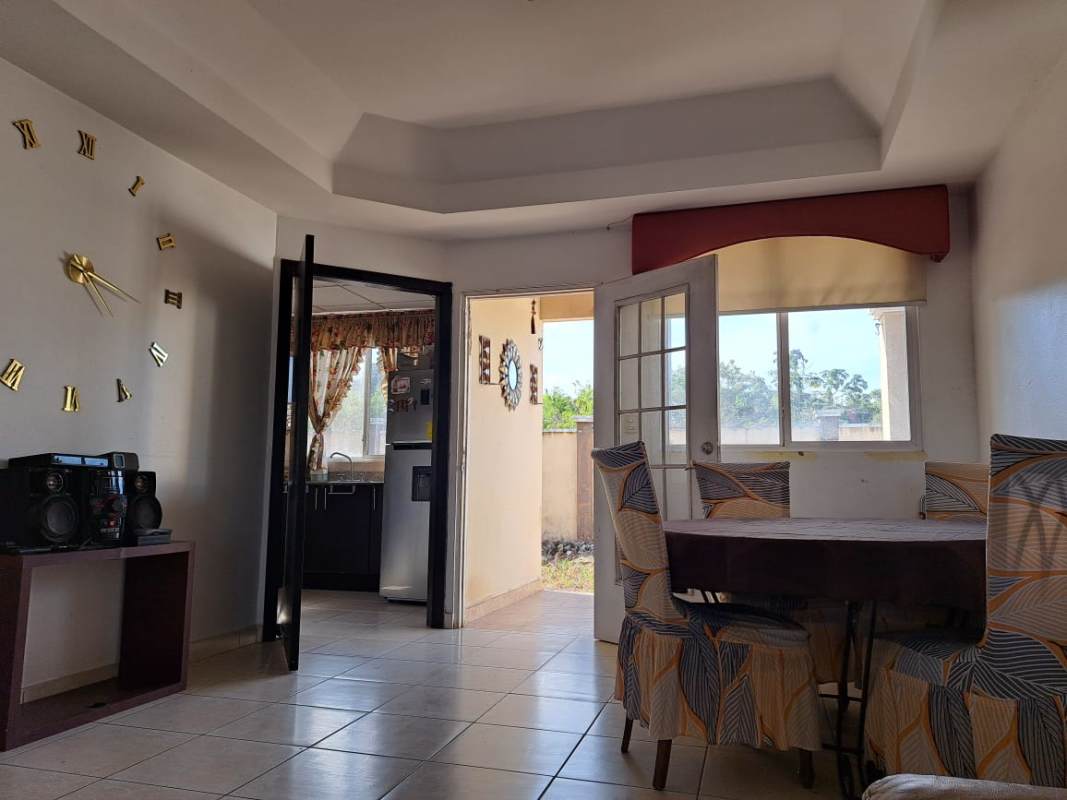 Bright living room and dining area with chandelier, tiled floors in PH Vista del Valle Villa Lucre Panama