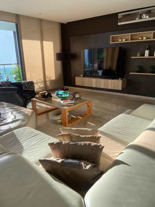 Bedroom with skyline city view, floral wallpaper, king bed, and large windows Punta Pacifica Panama