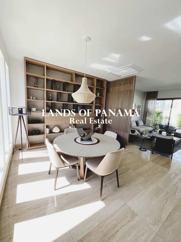 Large covered terrace with marble floors and garden views in luxury community