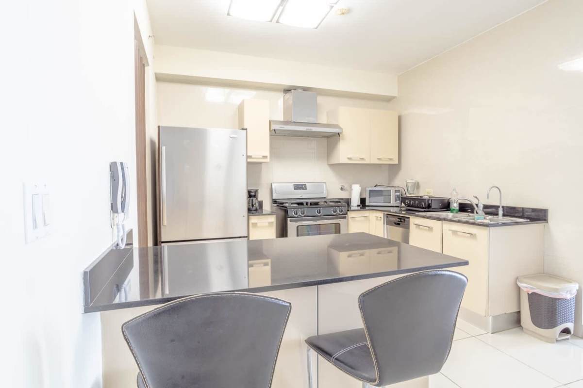 Contemporary kitchen with granite, stainless appliances, breakfast counter in PH Allure Panama