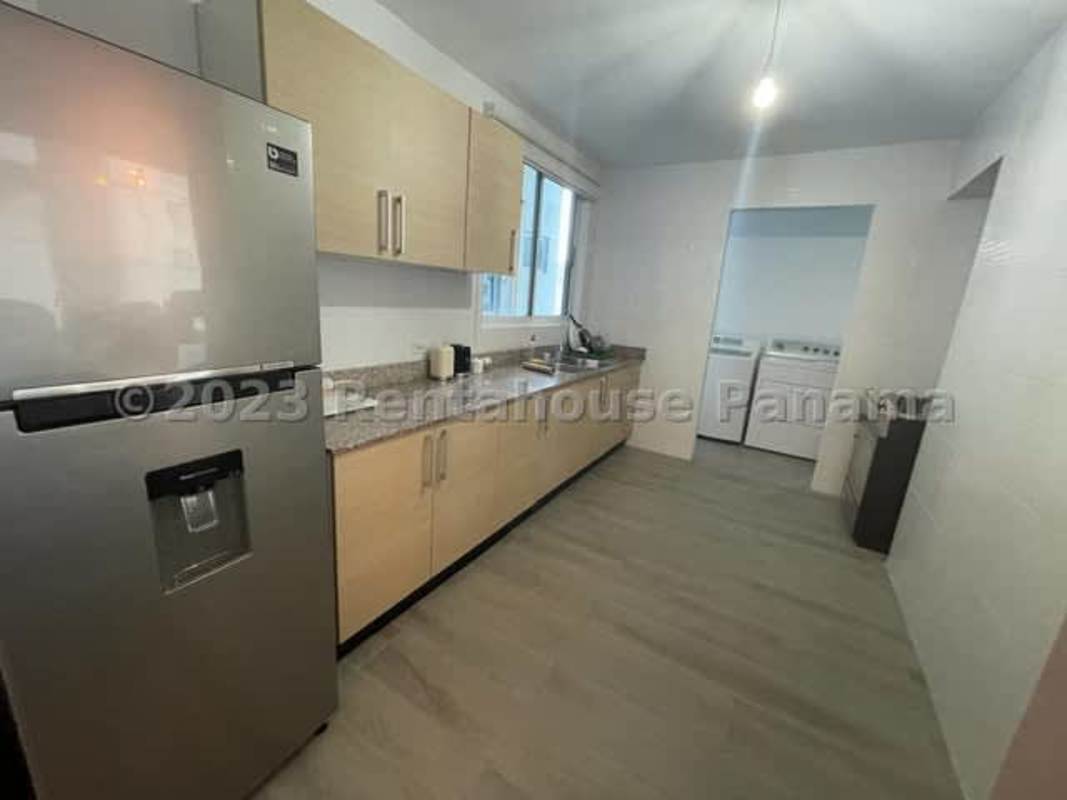 Kitchen in Bella Vista Loft apartment with granite countertops, stainless appliances and adjacent laundry area, Panama City