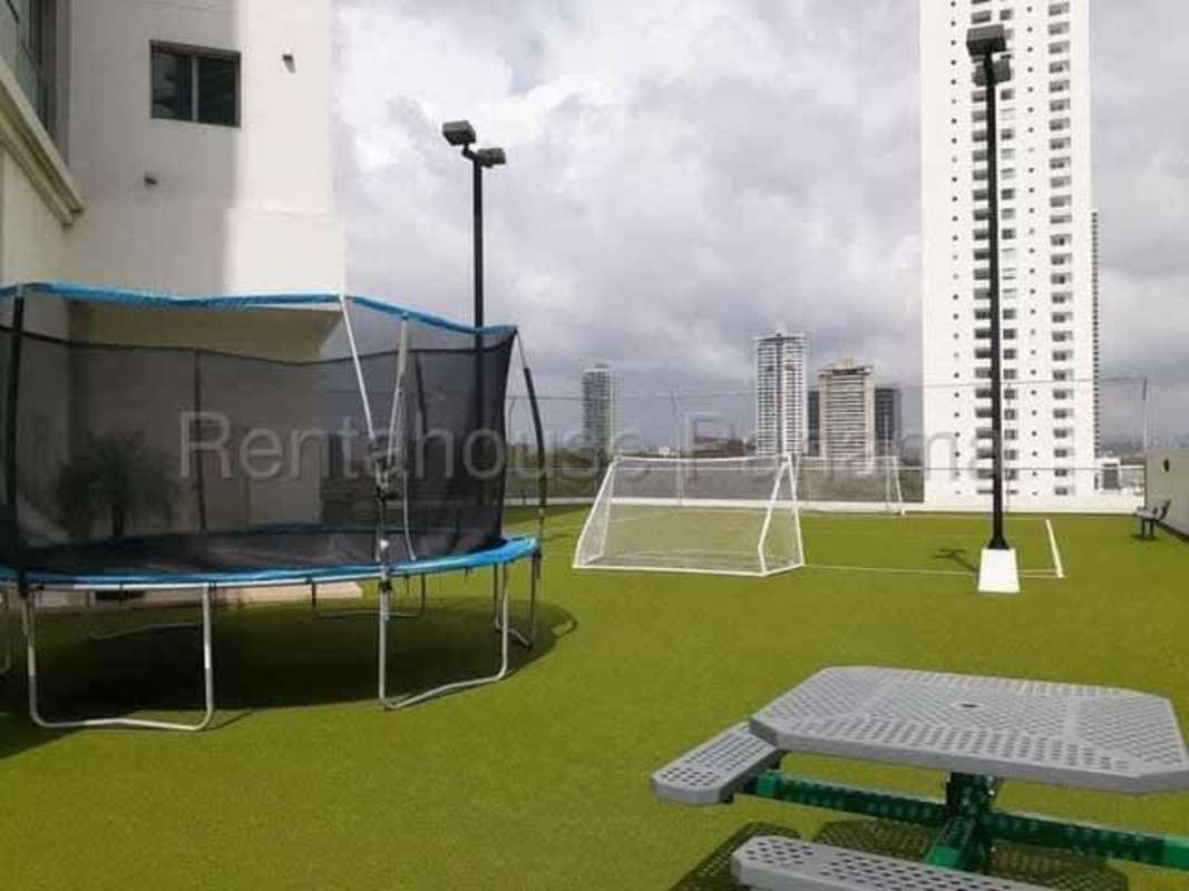 Modern rooftop kids play area with turf soccer goal trampoline city skyline Costa del Este Panama