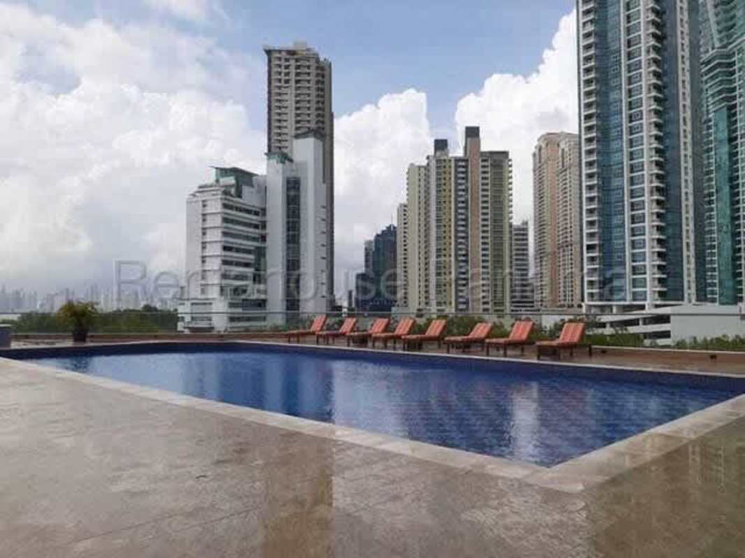 Infinity rooftop swimming pool with sun deck overlooking city skyline Costa del Este Panama