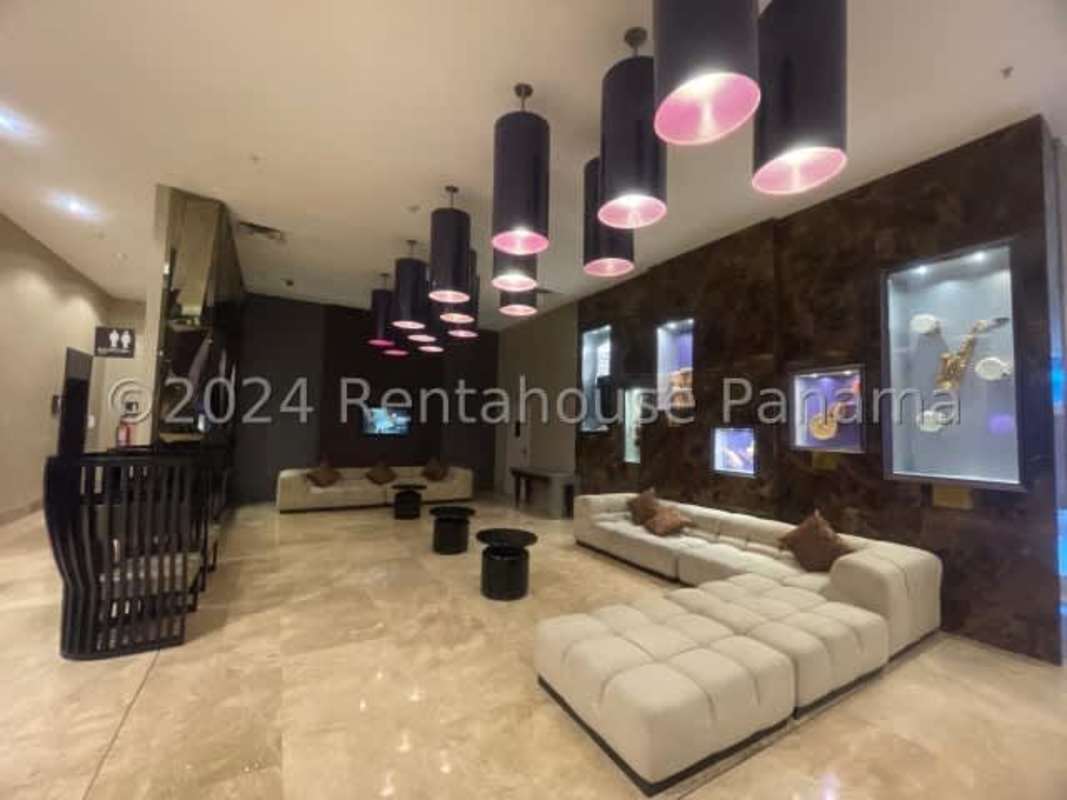 Modern bedroom with king bed, panoramic skyline views in Megapolis Tower Panama