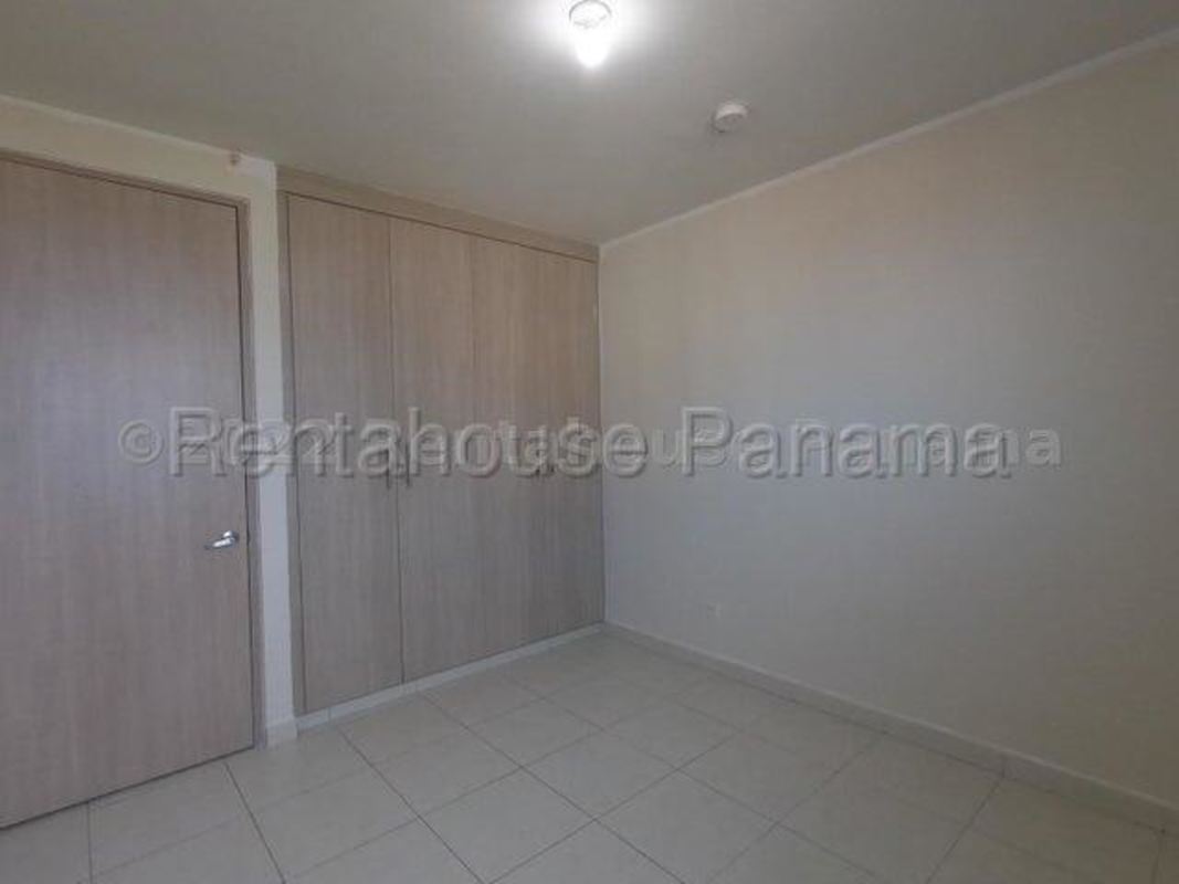 Empty bedroom with built-in wooden wardrobe tile floor urban apartment Versalles Panama