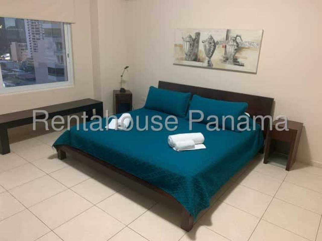 Bedroom with large window, ocean views, and built-in closets at PH Vista del Mar Panama City