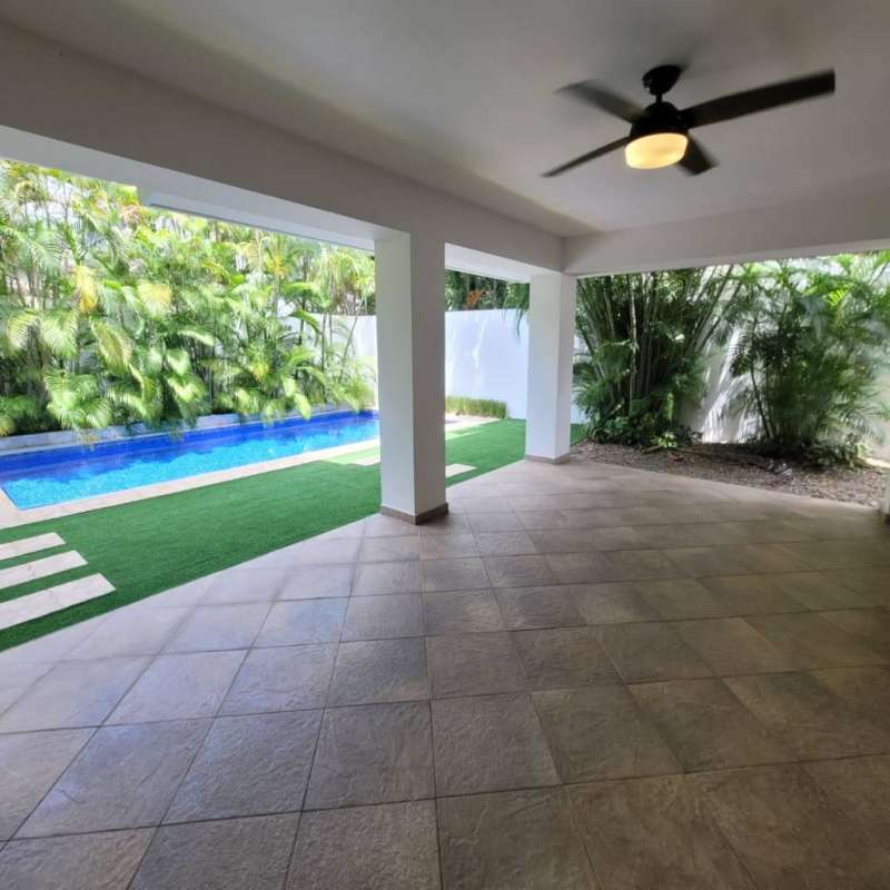 Patio terrace with swimming pool and tropical landscaping in Costa de las Perlas Panama
