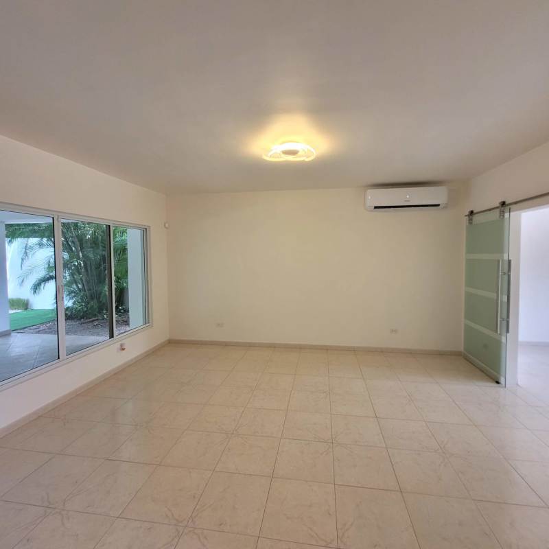 Contemporary living area with tile flooring and large windows in Costa del Este luxury house