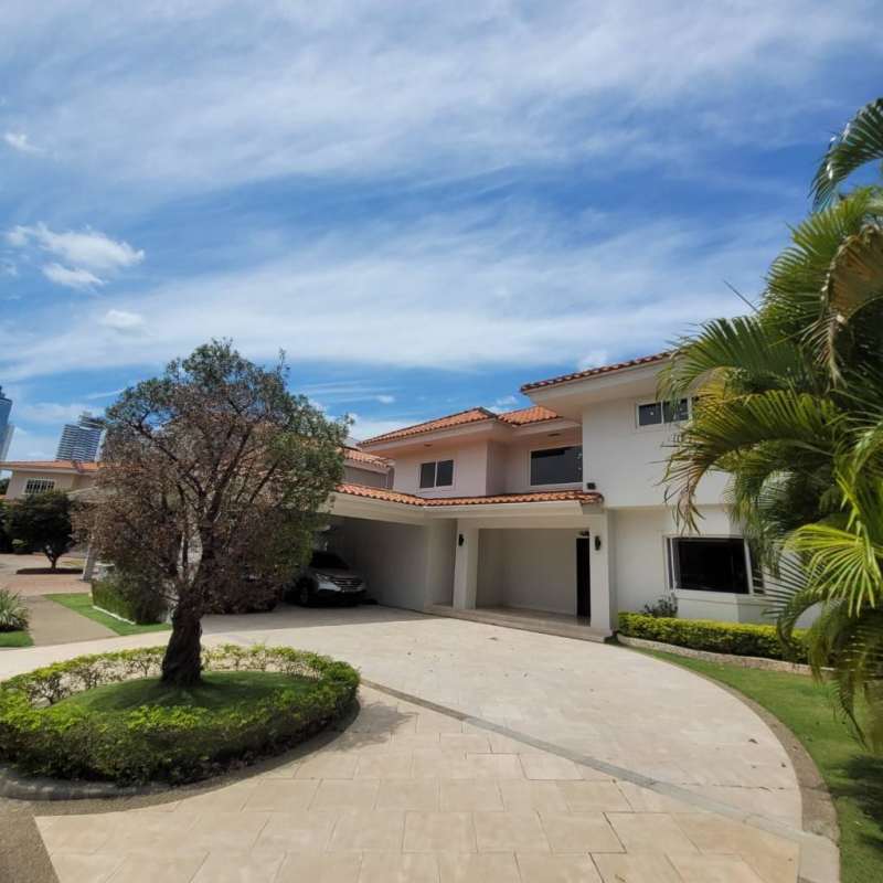 Two-story Mediterranean-style house exterior with driveway and garden in Costa del Este Panama