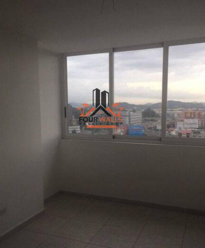 Bright bedroom with large window and city skyline view at PH Bay View Avenida Balboa Panama