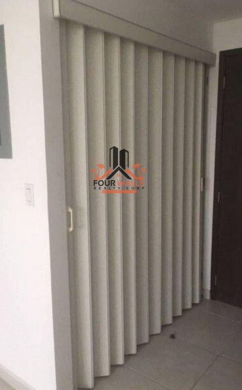 Interior hallway with sliding partition blinds and ceramic tile floor in PH Bay View Avenida Balboa Panama