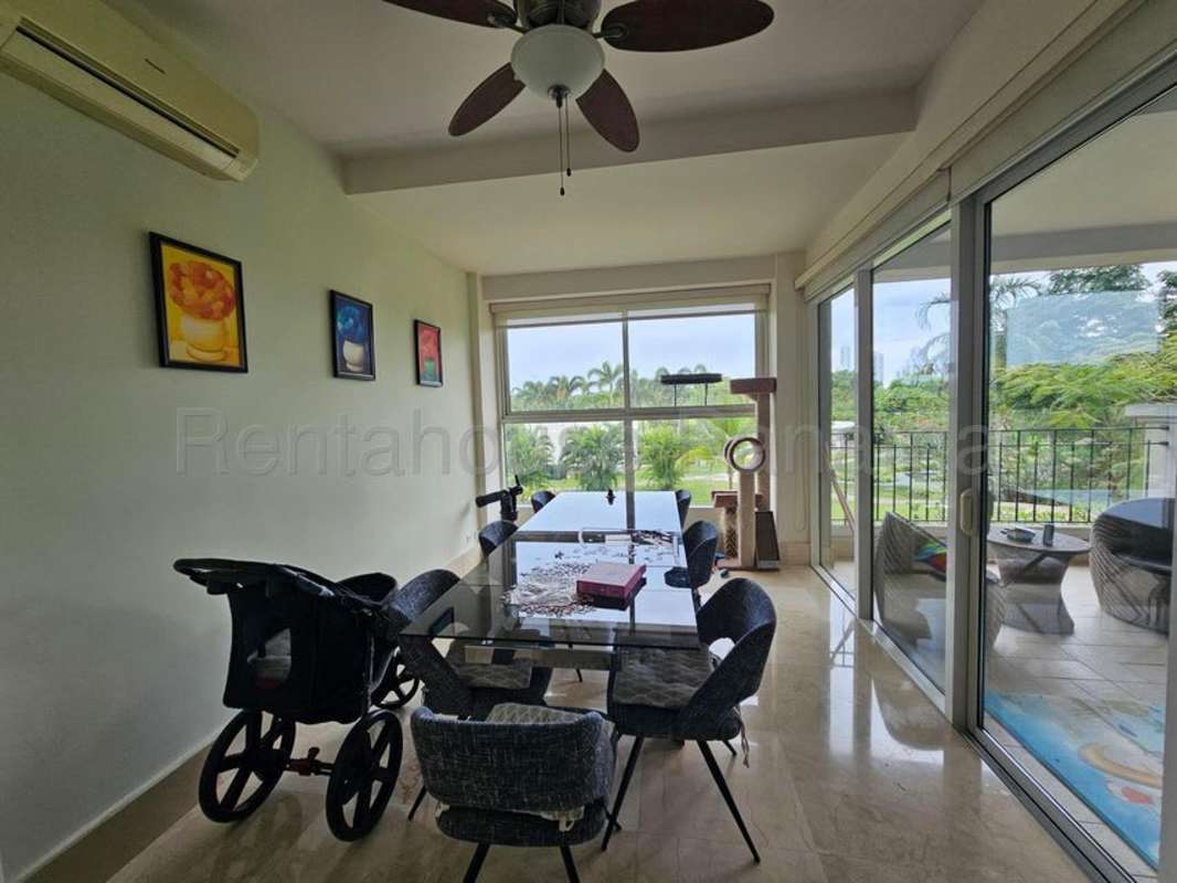 Modern dining area with marble floors and balcony golf views at PH Santa Maria luxury condo Panama
