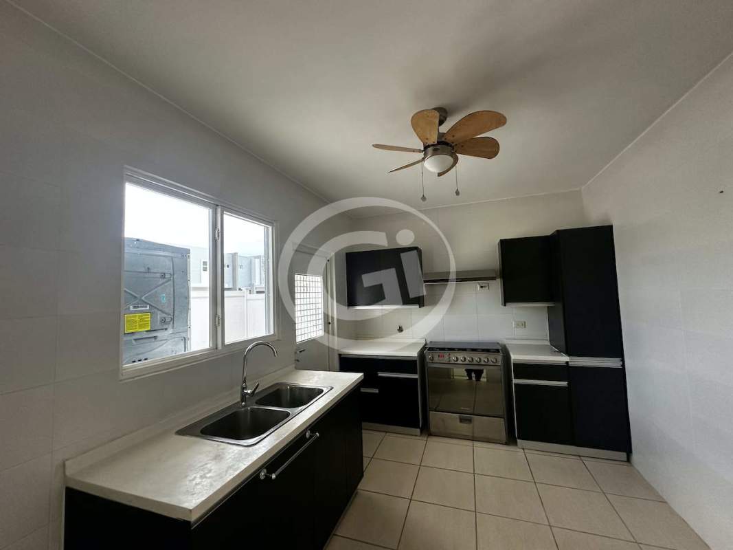 Kitchen with window black cabinets stainless steel oven ceiling fan PH Augusta Brisas del Golf