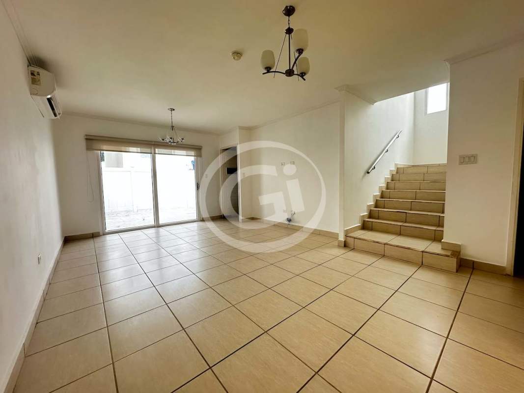 Bright living room with ceramic floors, large windows and staircase PH Augusta Brisas del Golf Panama