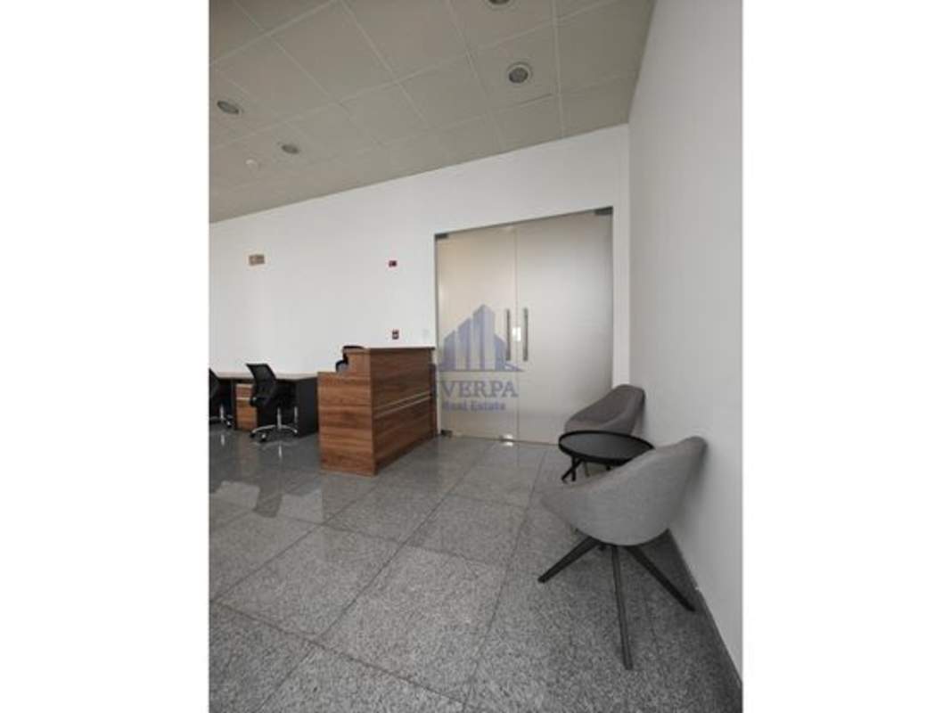 Reception lobby with wooden desk, granite flooring, glass doors in PH BICSA Tower Panama City