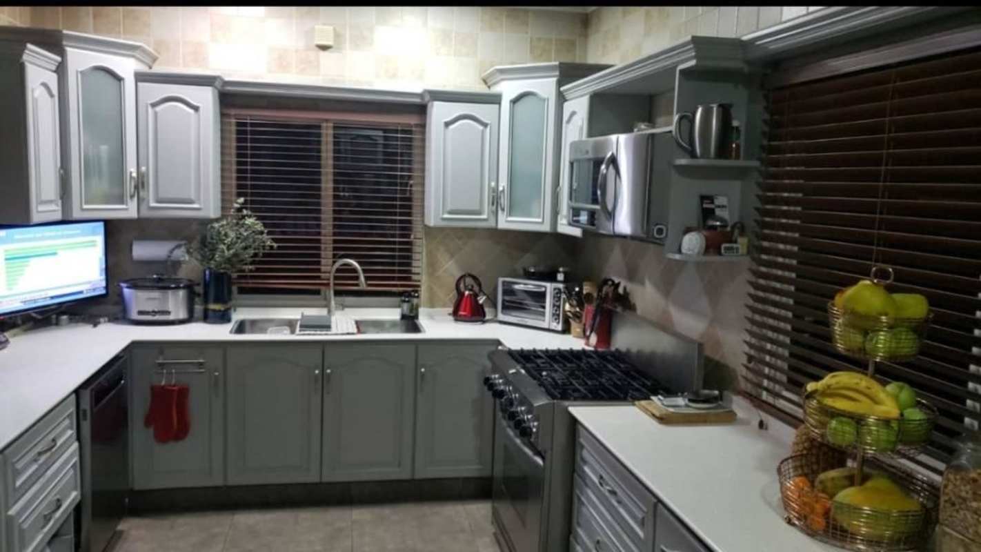 Open concept living dining area with white sofas and large windows in Urbanización Ancón house for rent