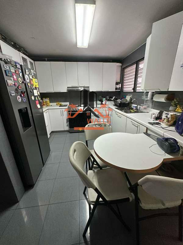 Contemporary white kitchen with tile floors and natural light in PH Bay View Avenida Balboa Panama City