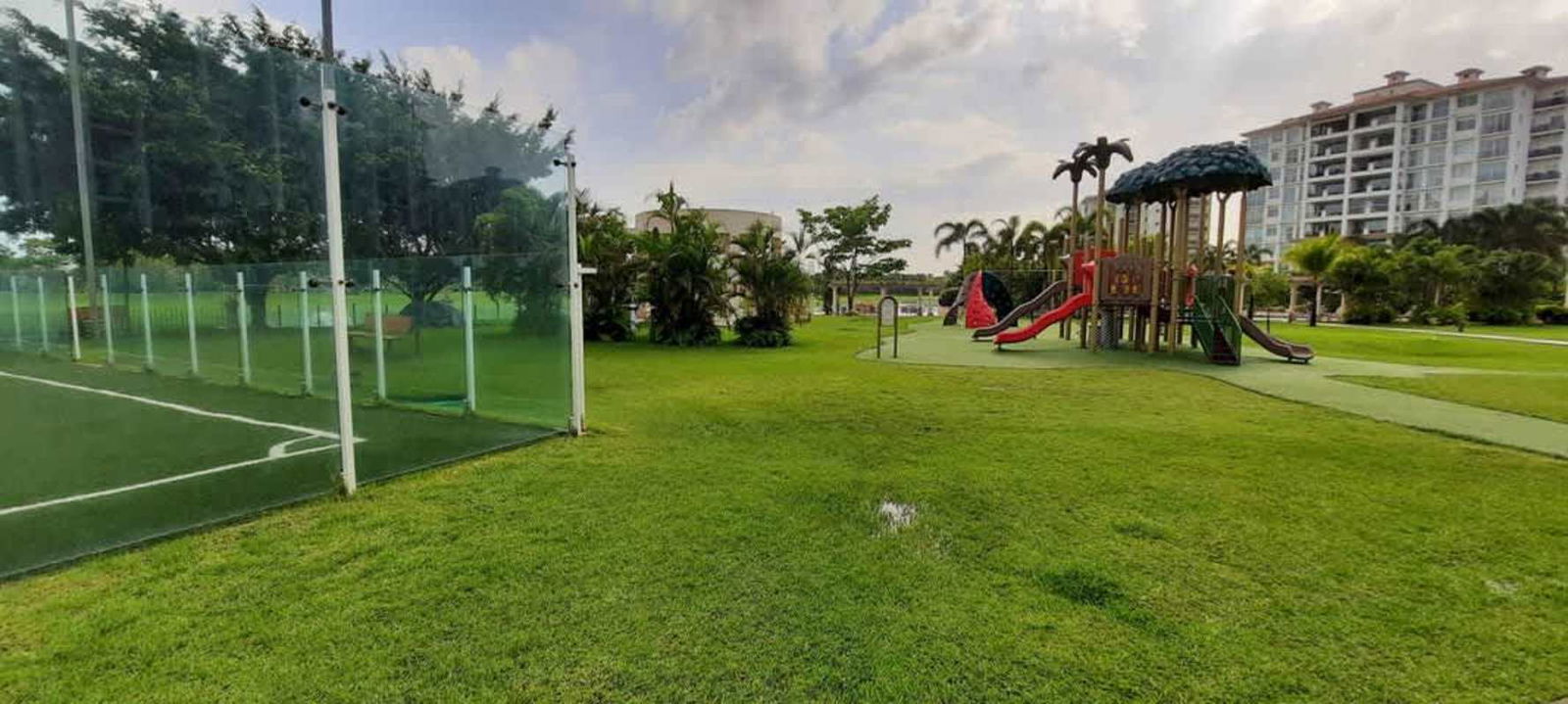 Resort-style lagoon pool with sun loungers and palm trees at The Reserve Santa María