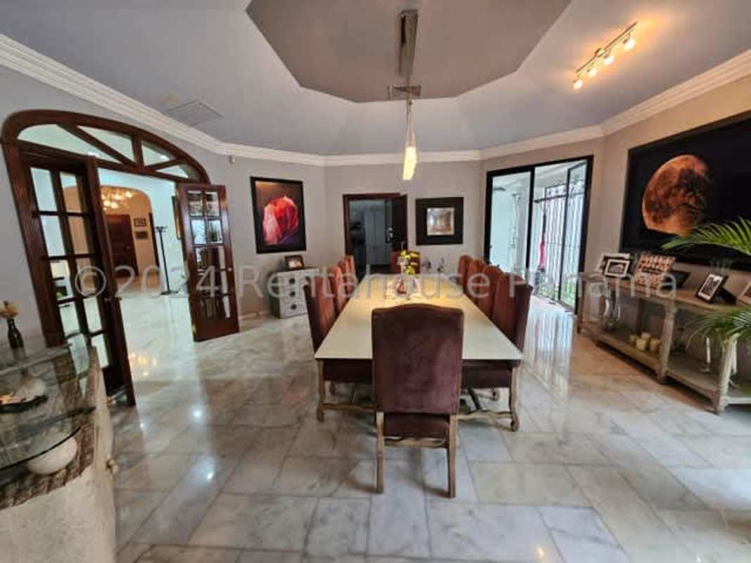 Spacious living room with marble floors, modern lighting and garden views in Altos del Golf luxury house Panama