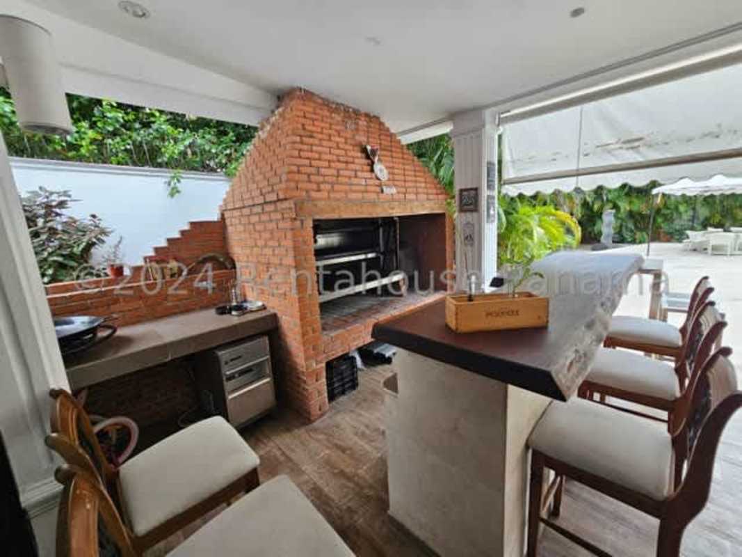 Spacious granite kitchen with island, stainless steel appliances in luxury house Altos del Golf Panama