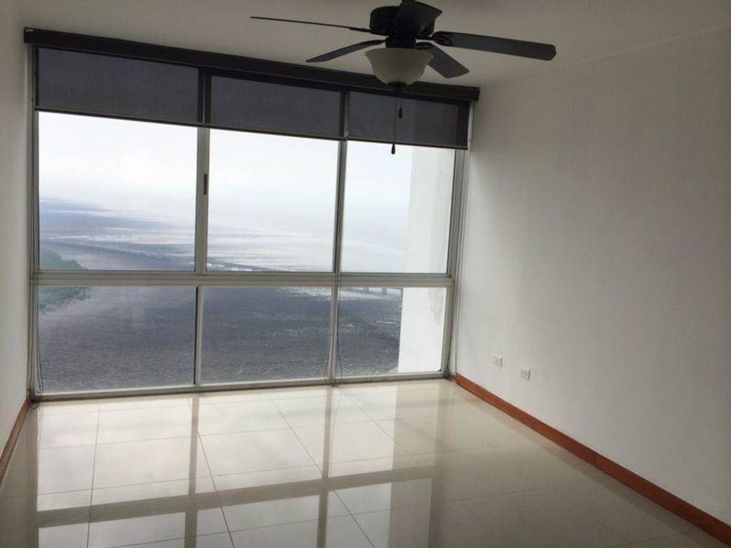 Living area with floor-to-ceiling windows and ocean view at PH Bahia del Golf penthouse in Coco del Mar Panama