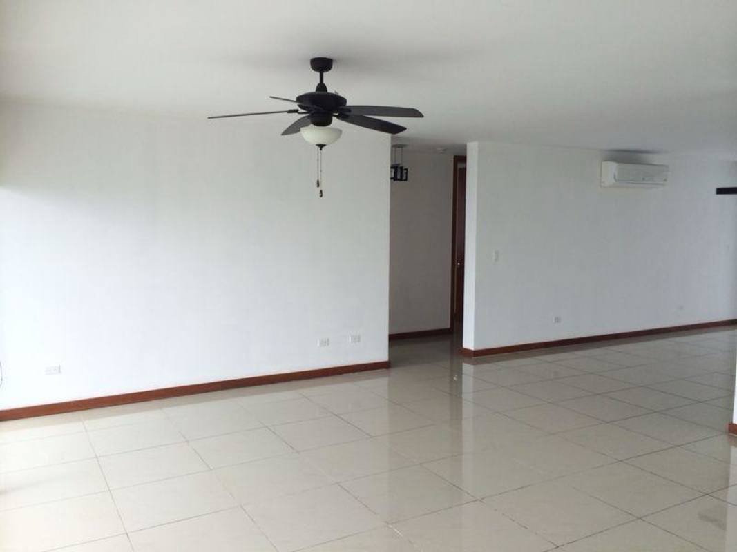 Large modern living room with split AC, ceiling fan, light ceramic floors at penthouse in PH Bahia del Golf Coco del Mar Panama