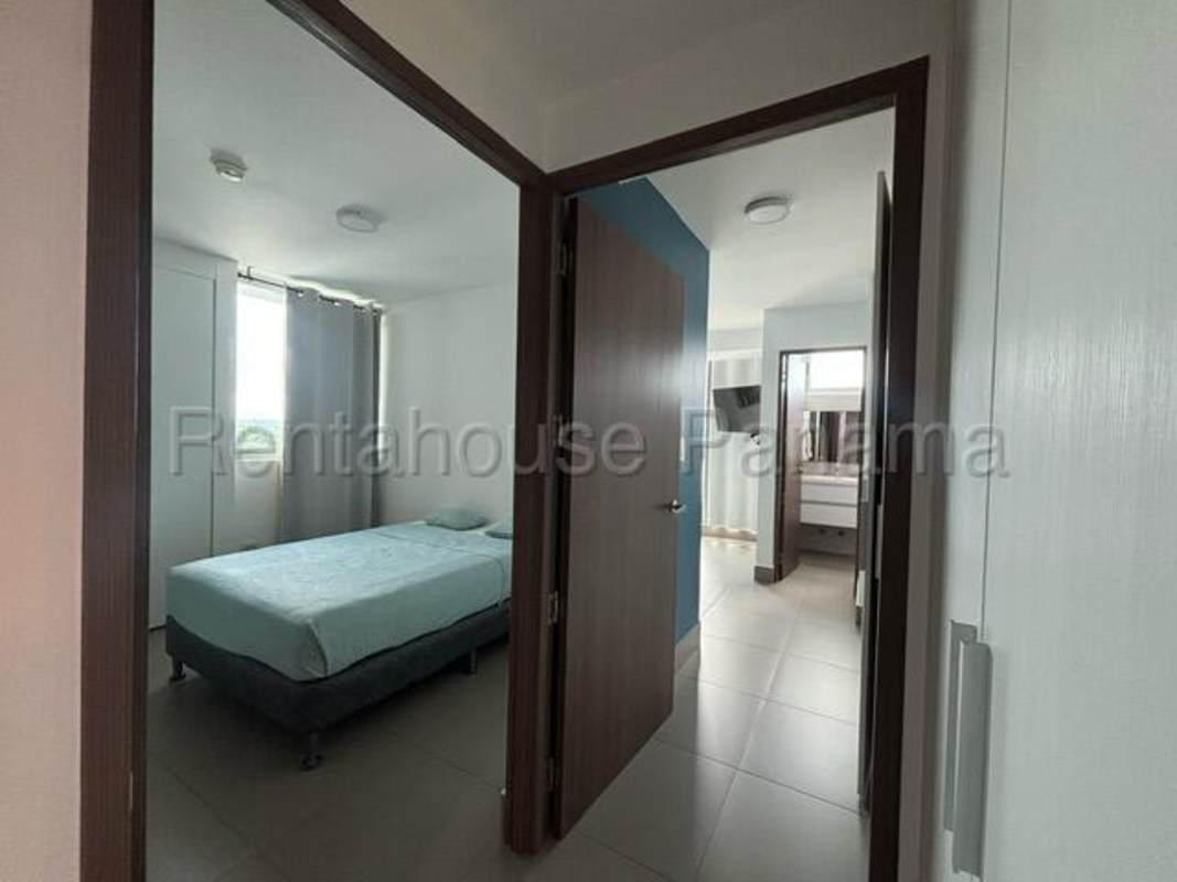 Modern kitchen with appliances, breakfast bar, and laundry area in Altamira Residences Panama