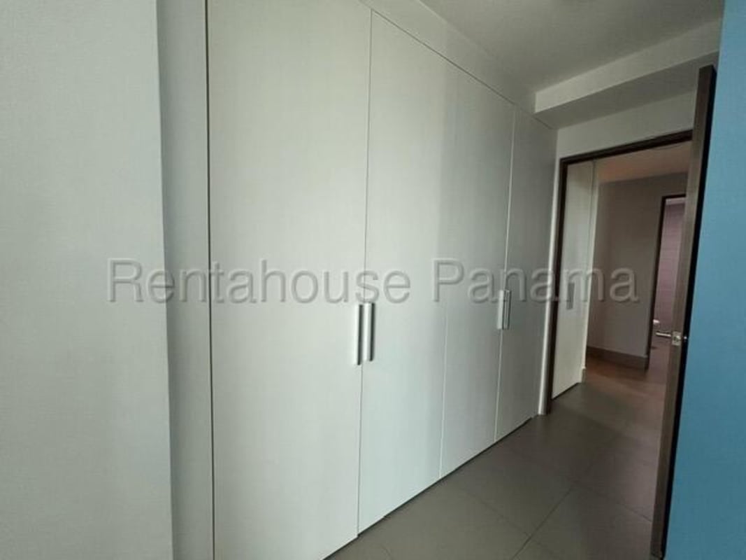 Spacious modern living room with large windows and city views at Altamira Residences