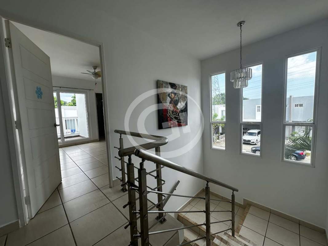 Swimming pool area with lounge chairs in PH Augusta residential community Panama City