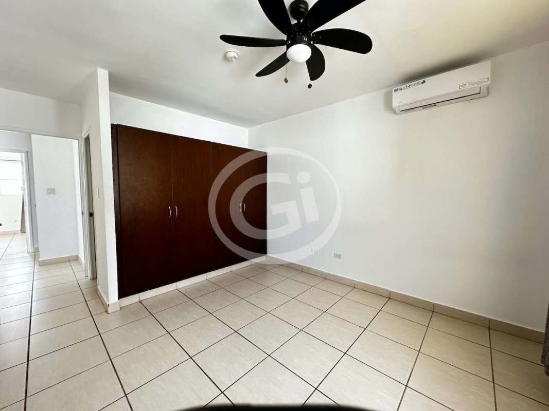 Bright unfurnished living room with tiled floors in corner house PH Augusta Panama City