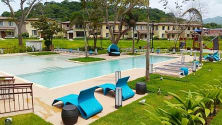 Swimming pool with gardens and social area at River Valley Panama Pacifico