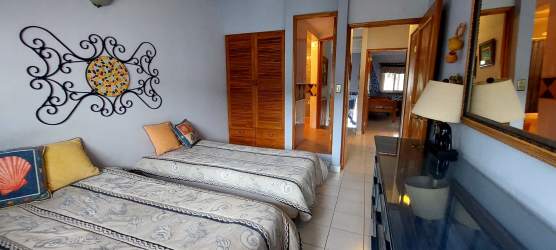 Bedroom with twin beds art wood closet tile floor APRUCC beach duplex Gorgona