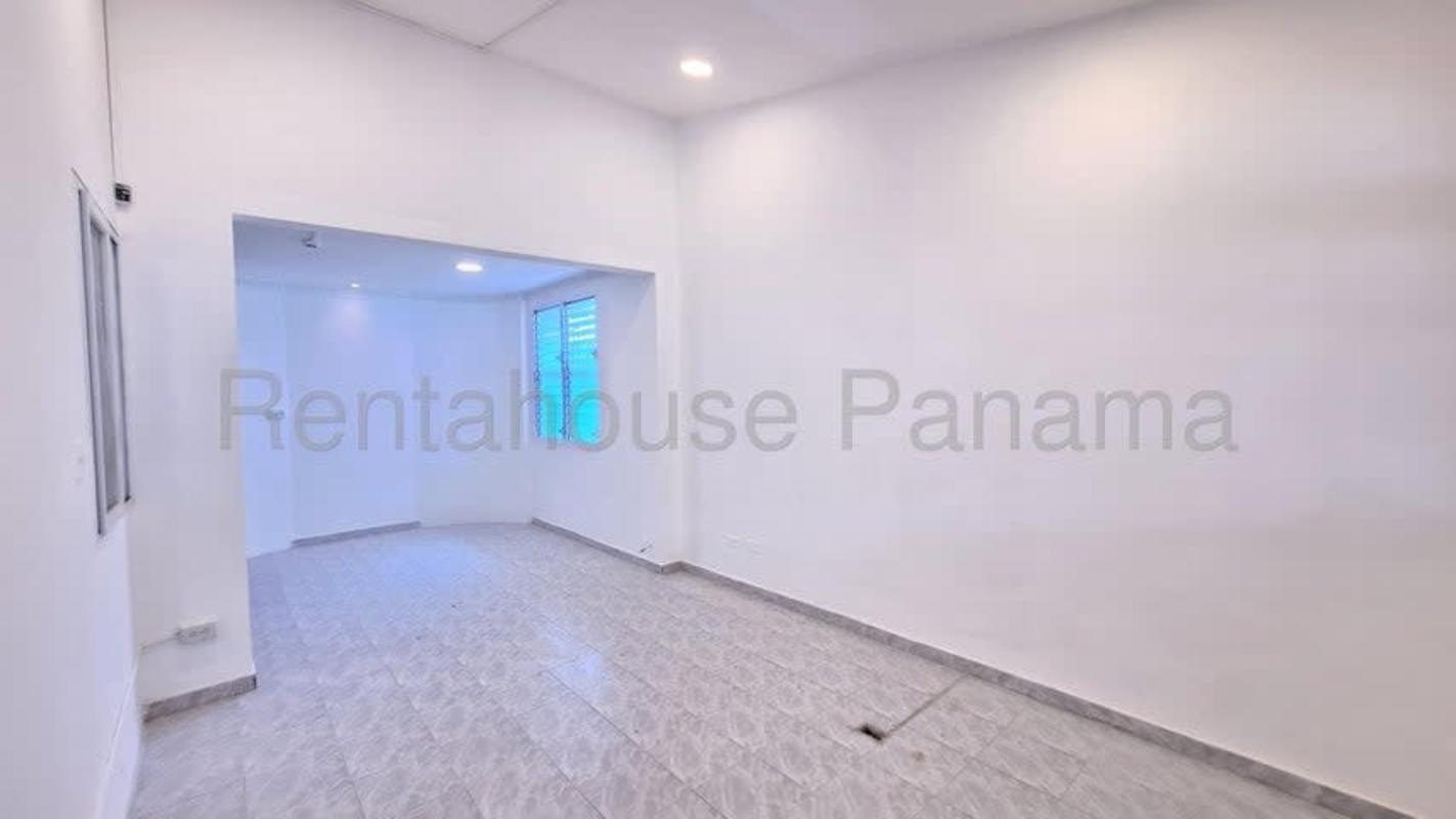 Kitchen with gray cabinets, marble effect tiles, double sink and security window in Altos de Panamá